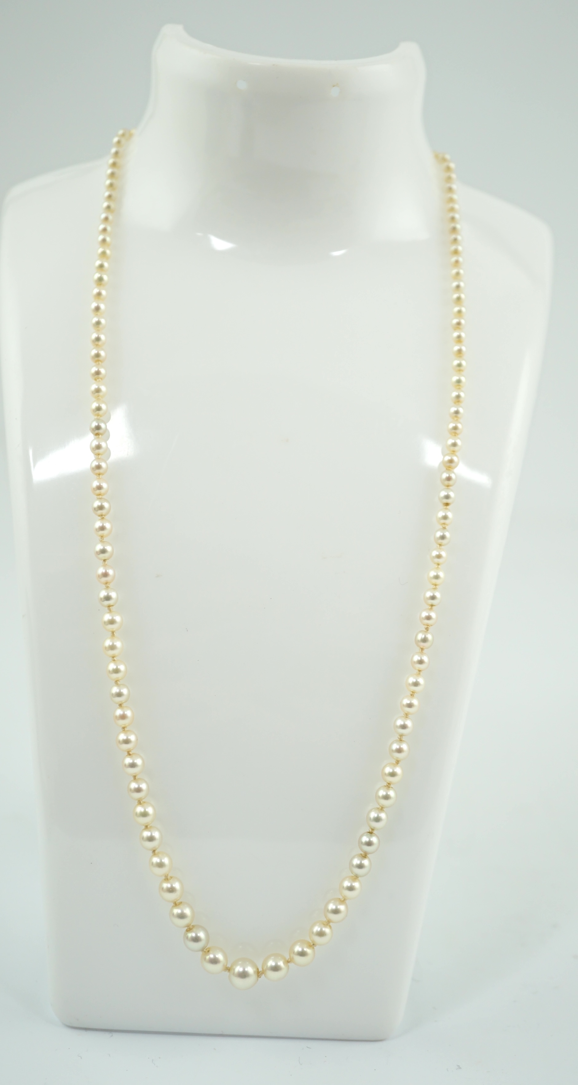 A single strand graduated cultured pearl necklace, with emerald and diamond cluster set gold clasp